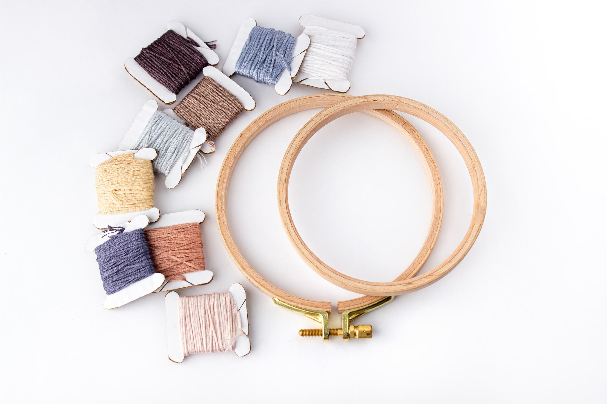 Cozy studio workspace with embroidery hoops and threads