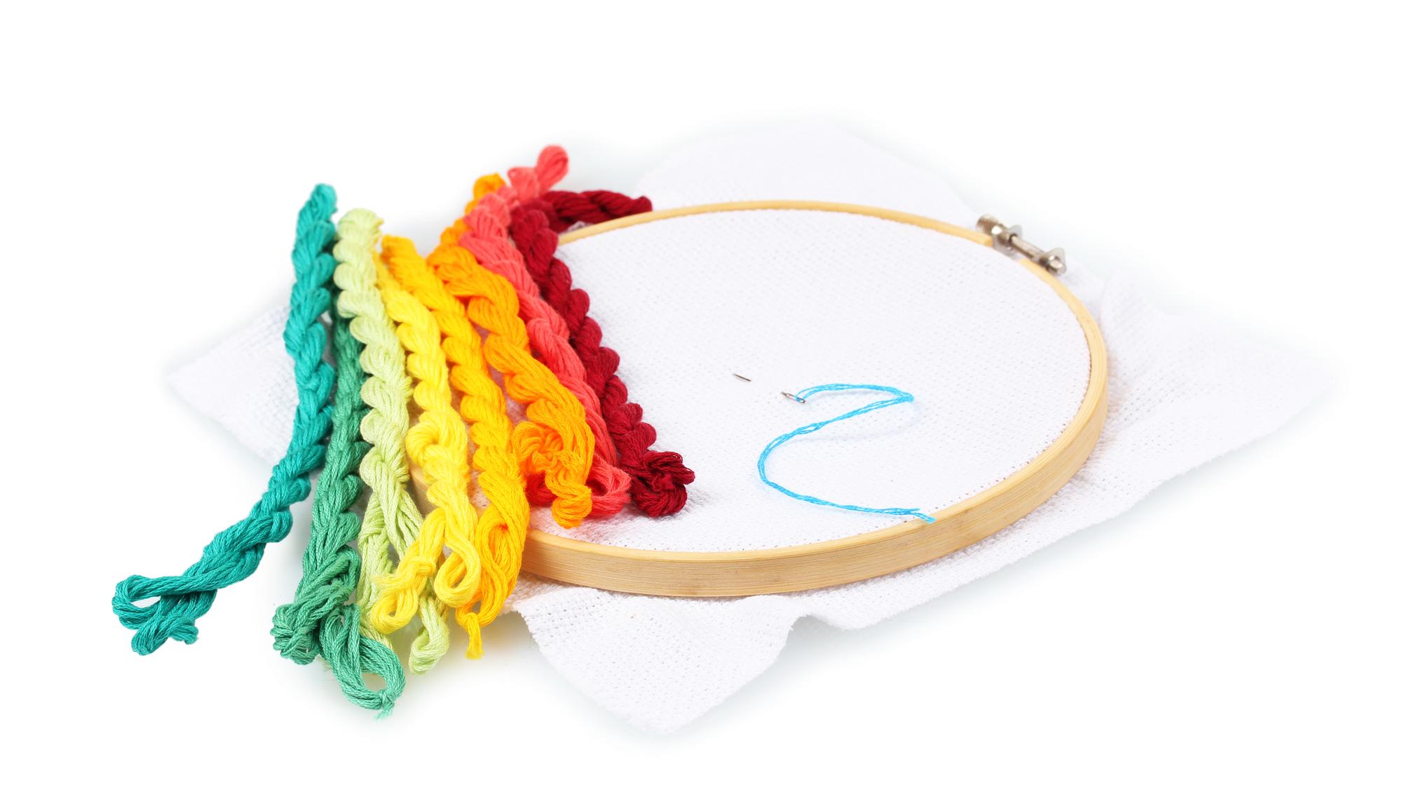 Instructor demonstrating embroidery stitch with hoop