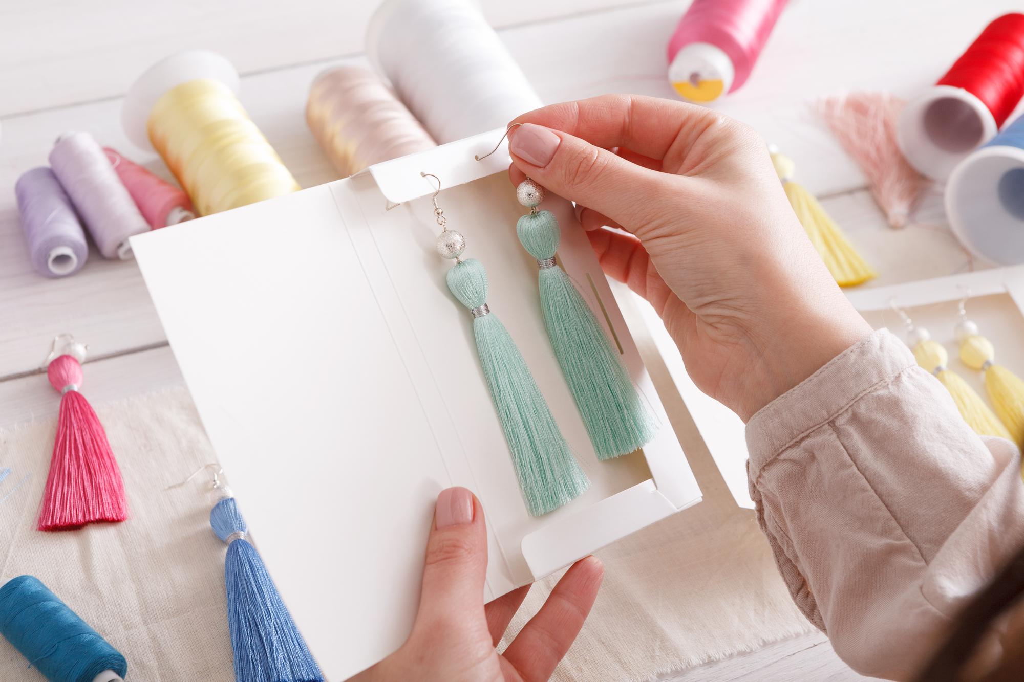 Hand holding sample embroidery booklet